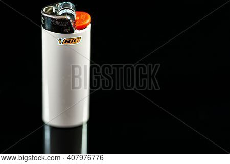 Miercurea Ciuc, Romania- 13 February 2021: Bic Cigarette Lighter On Dark Reflecting Surface Close Up