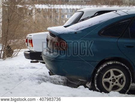 Kazakhstan, Ust-kamenogorsk, January 28, 2020: Two Cars Parked. Back View. Winter Snow. Mazda And La