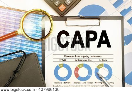 Business And Finance Concept. On The Table Are Charts With Reports, A Notebook, A Magnifying Glass A