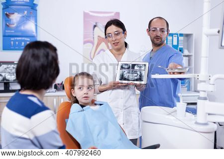 Dentist Discussing About Cavity Prevention With Little Girl Parent Stomatologist Explaining Teeth Di