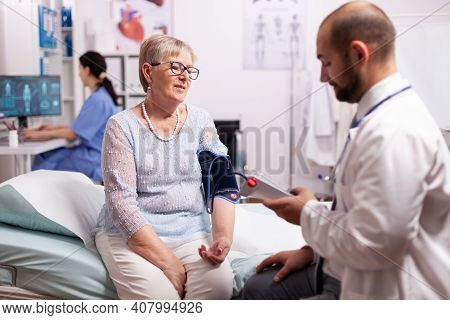 Doctor Checking Woman Tension Using Portable Arm Digital Preassure To Check Blood Flow. Healthcare M