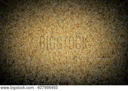 Dried Garlic Granules On Brown Olive Wood