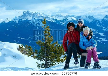 Family Walking On Winter Mountain Slope