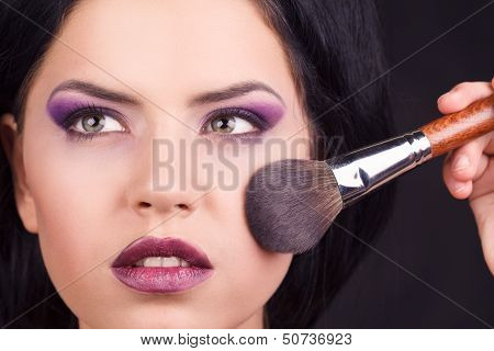 Portrait beautiful white hair girl with makeup brushes near the face