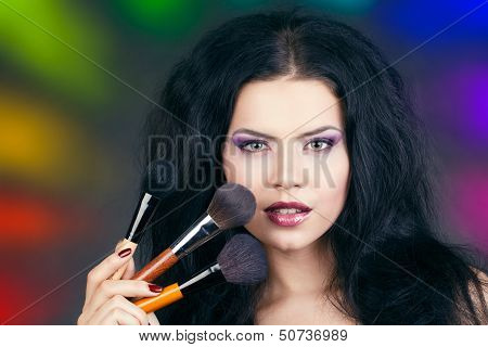 Portrait beautiful white hair girl with makeup brushes near the face