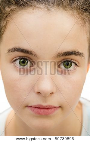 Closeup Portrait Of A Beautiful Young Girl, With Big Green Eyes Looking Into The Camera, Isolated On