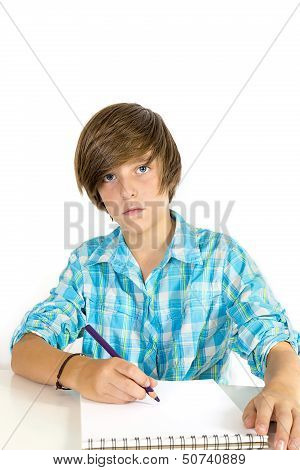 School Boy Working With A Pencil, Isolated On White