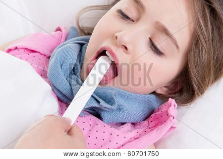 Pediatrician Examining Little Girl's Throat.
