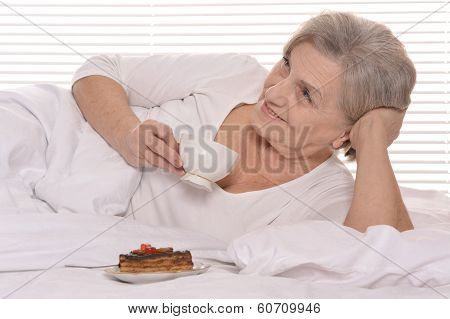 Beautiful older woman resting in the bedroom