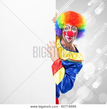 Smiling clown holding a blank sign