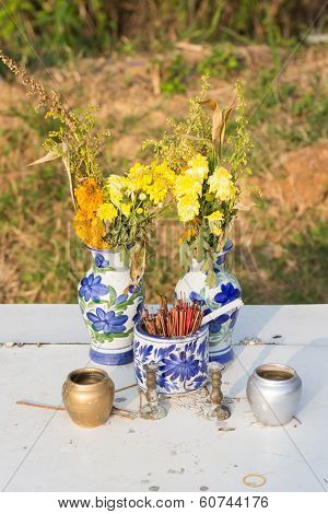 Joss Sticks And Flower In A Jar For A Spirit House With A Colorful Wreath In Thailand
