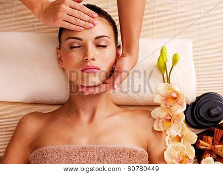 Masseur Doing Massage The Head Of An Woman In Spa Salon