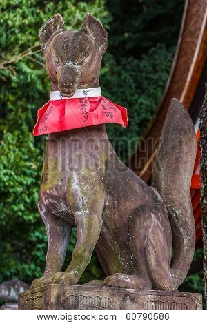 Kyoto, Japan - November 19 2013: Kitsune Fox Statues Hold A Symbolic Item In Their Mouths Or Beneath
