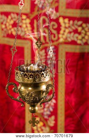 Copper church thurible with smoking incense in it