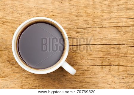 Black Coffee In White Ceramic Cup On Wooden Table - View From Top