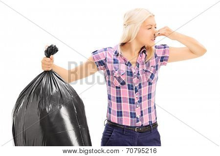 Woman holding a smelly garbage bag isolated on white background
