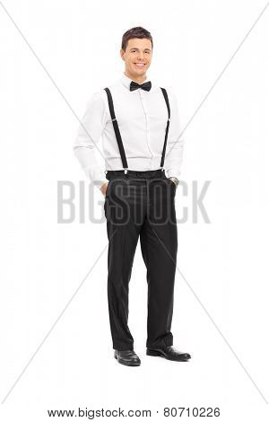 Full length portrait of a fashionable young man with bow-tie posing isolated on white background