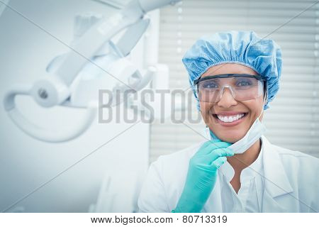 Portrait of female dentist wearing surgical cap and safety glasses