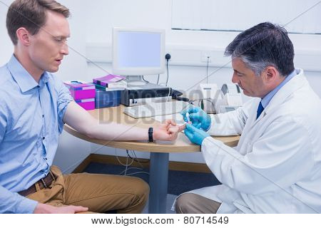 Doctor testing his patients blood at the hospital