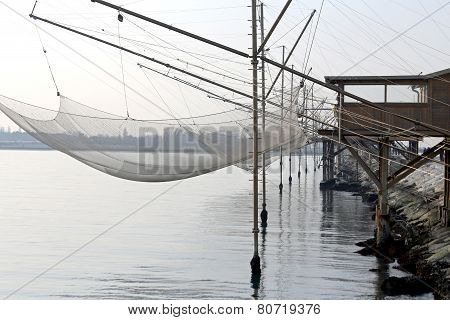 Fishing Nets Over The Pile Dwellings