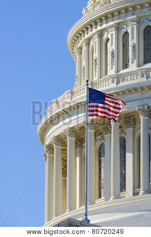 US Capitol Building dome detail with waving national flag - Washington DC, United States of America