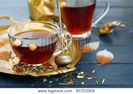 Beautiful vintage composition with herbal tea, on wooden table