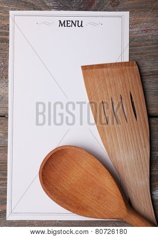 Menu sheet of paper on rustic wooden surface background