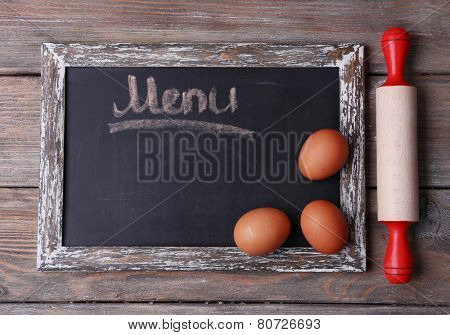 Blackboard menu on rustic wooden planks background