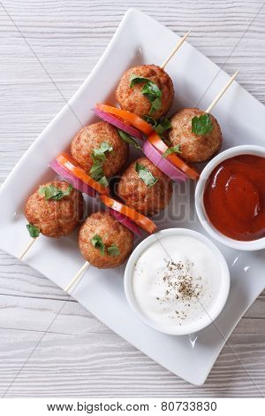 Meatballs On Skewers And Sauces Vertical Top View