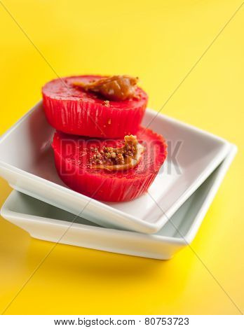 Kutsinta - a Filipino sweet rice cakes in white plates on bright yellow background.
