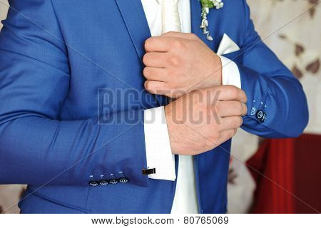 Man Puts Cufflinks