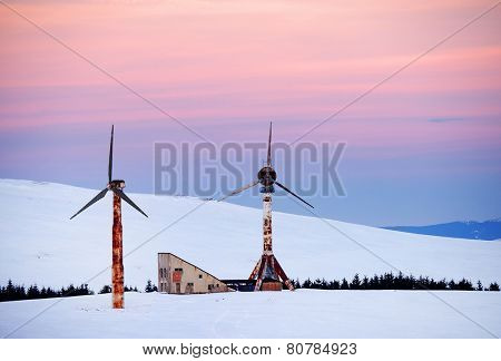 Abandonned wind turbines in winter landscape - sunset light