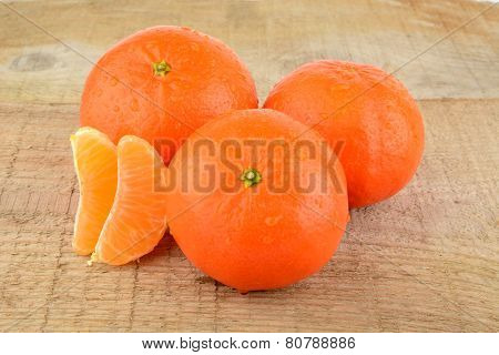 Mandarines With Pieces Isolated On Wooden Table