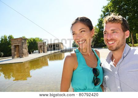 Madrid tourist couple by Temple of Debod. Tourists sightseeing in Madrid visiting tourist destinations and attractions in Madrid, Spain. Asian woman, Caucasian man.