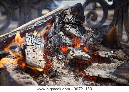 Burning Smoldering Firewood In The Fireplace Close Up. Firewood. Coals. Extinguished The Fire. The A