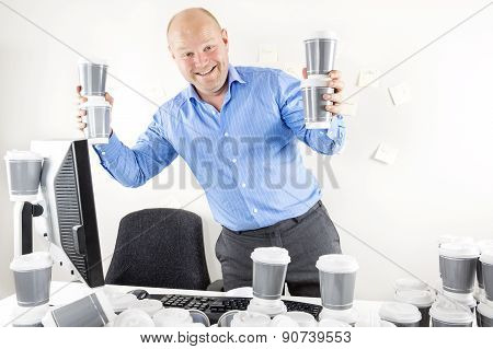 Happy businessman drinks too much coffee