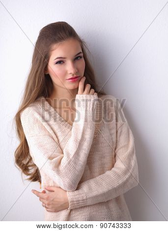 A young woman standing, isolated on graybackground