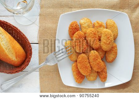 chicken nuggets served in a white bowl, top view