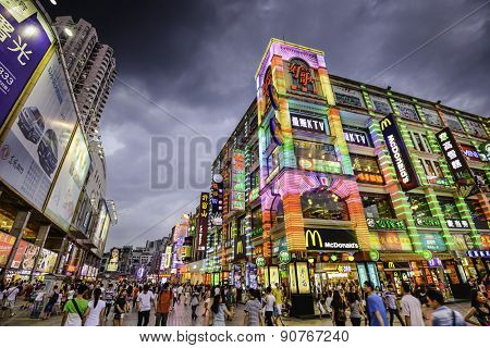 GUANGZHOU, CHINA - MAY 25, 2014: Pedestrians pass through Shangxiajiu Pedestrian Street. The street is the main shopping district of the city and a major tourist attraction.