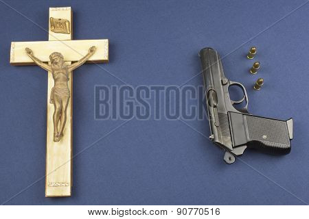 wooden crucifix with the lettering INRI and gun