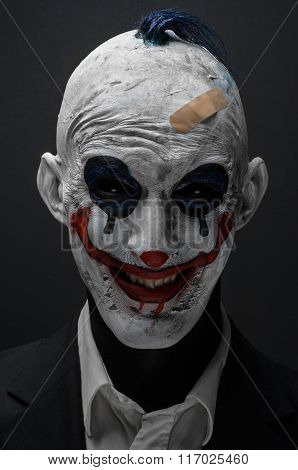 Terrible Clown And Halloween Theme: Crazy Terrible Blue Clown In Black Suit Isolated On A Dark Backg