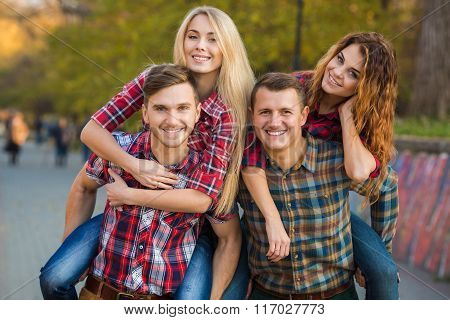 Two young couples spend time in the Park in early autumn
