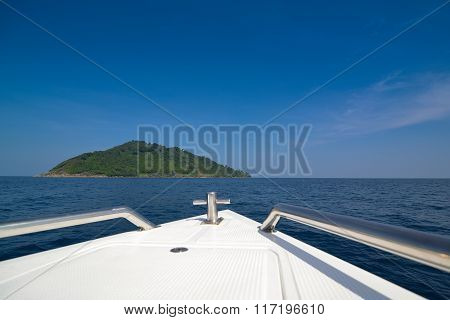 Speed boat bow while heading to island with blue sky