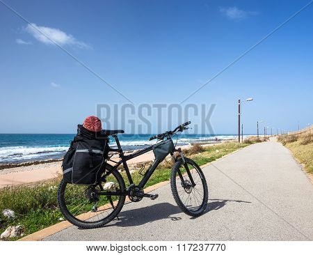 Bicycle is on road near sea