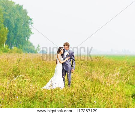 Just married couple embraced.
