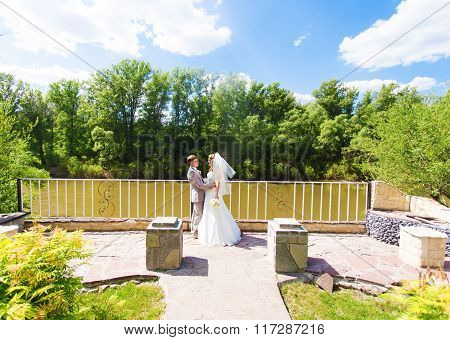 Just married couple embraced.