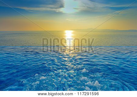 Swimming Pool With Sunset On The Sea