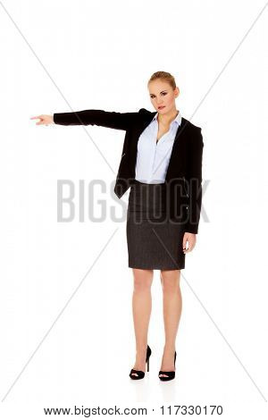 Angry business woman shows get out gesture