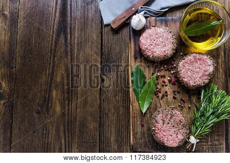 Seasonig Minced Meat Steaks On Wooden Board