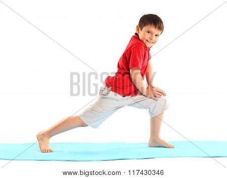 Children's yoga. The little boy does exercise.